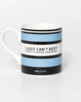 Mug with blue and black striped design and quite from iconic cyclist Beryl Burton, on a white background