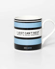 Mug with blue and black striped design and quite from iconic cyclist Beryl Burton, on a white background