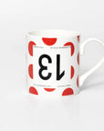 Mug featuring the number 13 upside down on a polka dot back ground in the style of Tour de France King of the Mountains jersey.