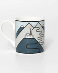 Mug with famous cycling destination mountain and tower design on a white background