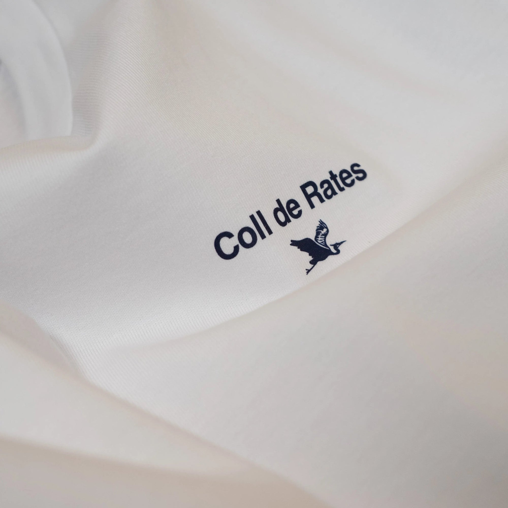 Close-up of white Climbs Profiles T-shirt with Spanish cycling climb Coll de Rates' logo, by the Handmade Cyclist