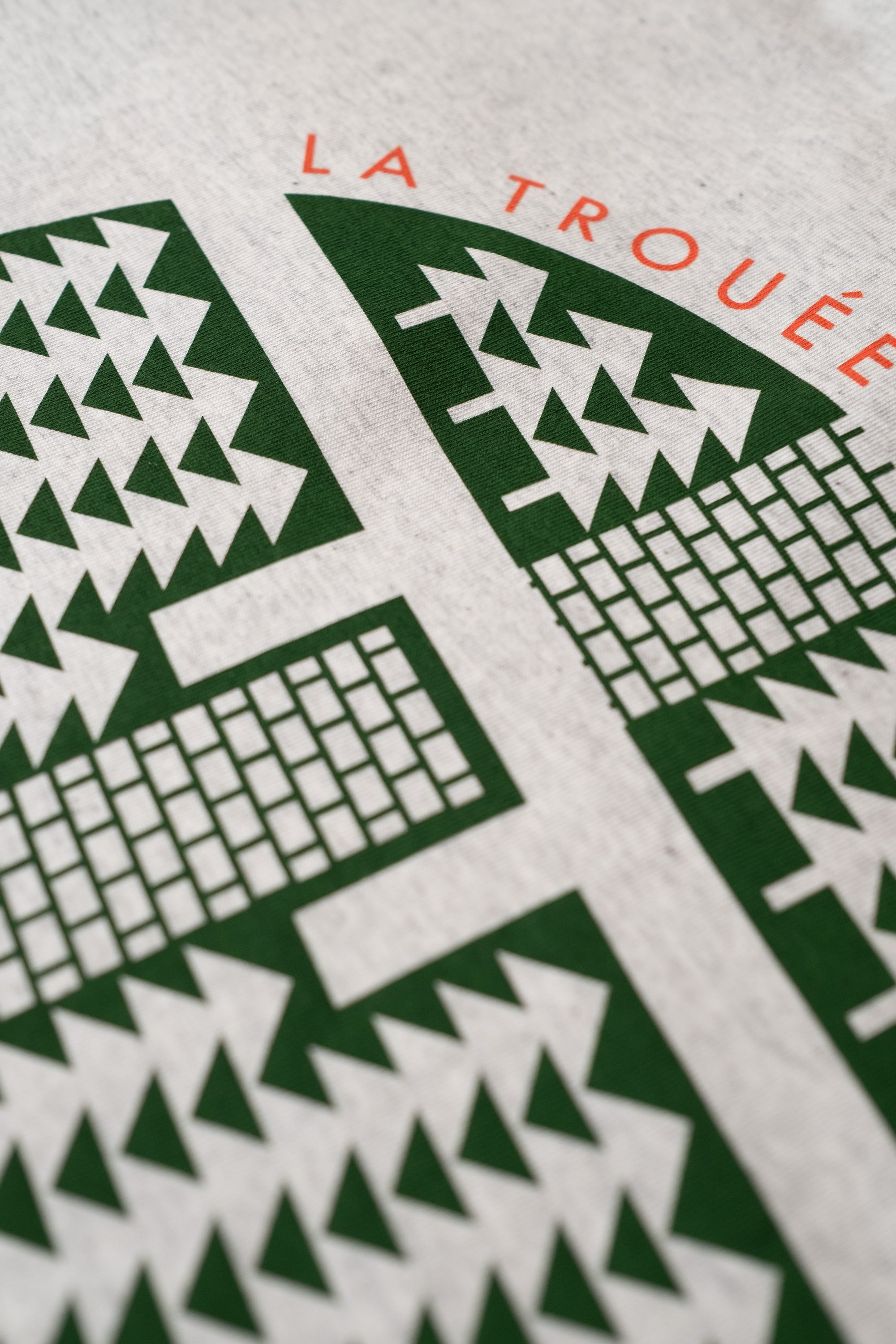 Close-up of a cycling t-shirt with geometric design and La Trouee D'arenberg print design by The Handmade Cyclist.