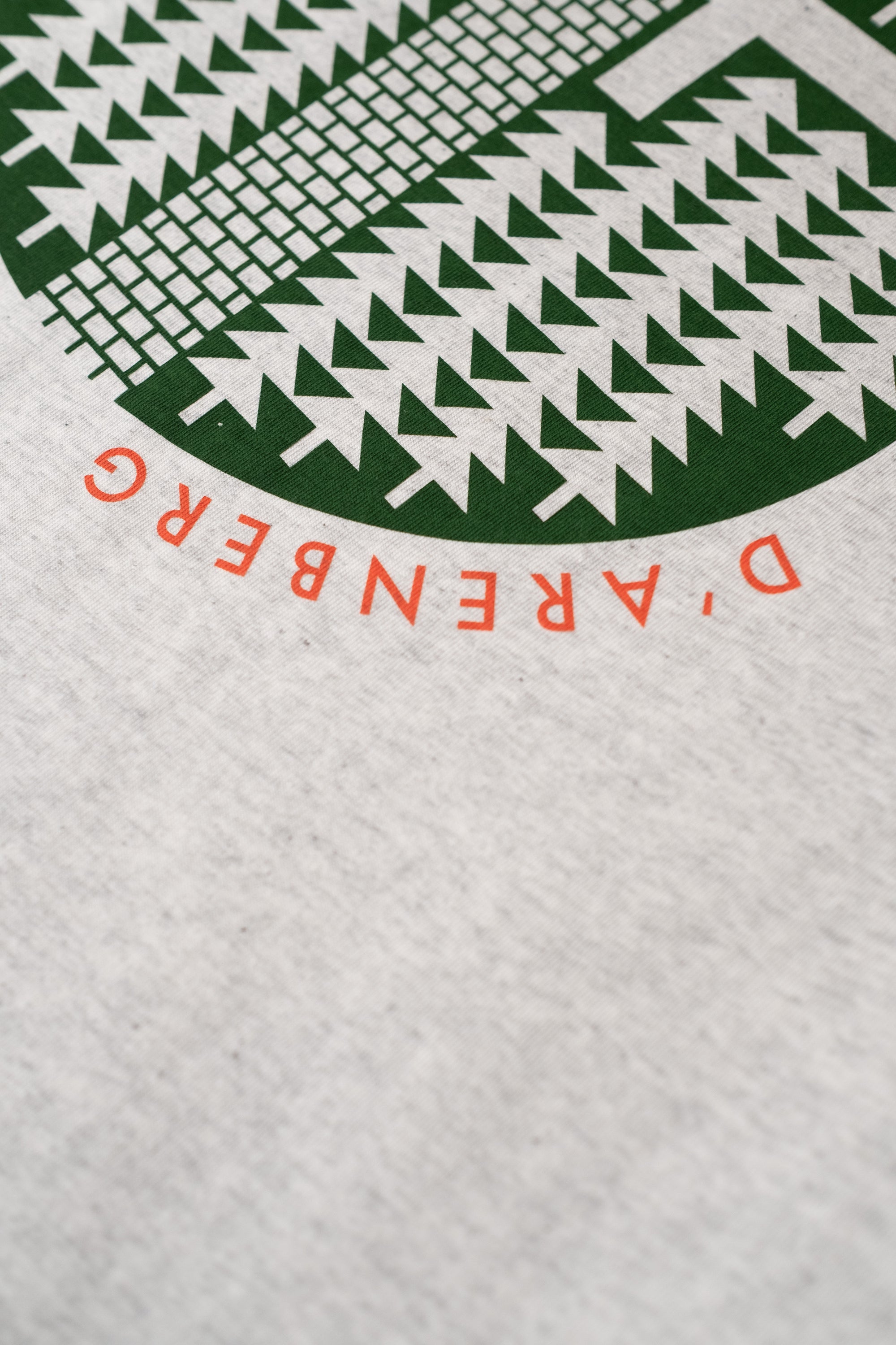 Close-up of a cycling t-shirt with geometric design and Trouee D'arenberg print design by The Handmade Cyclist.