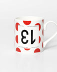 Polka Dot mug with black 13 in the style of a Tour de France cyclist's race number.