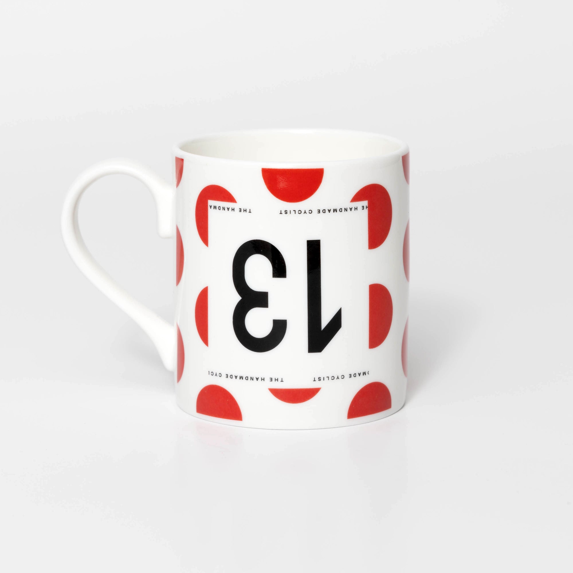 Polka Dot mug with black 13 in the style of a Tour de France cyclist's race number.