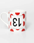 Polka Dot mug with black 13 in the style of a Tour de France cyclist's race number.