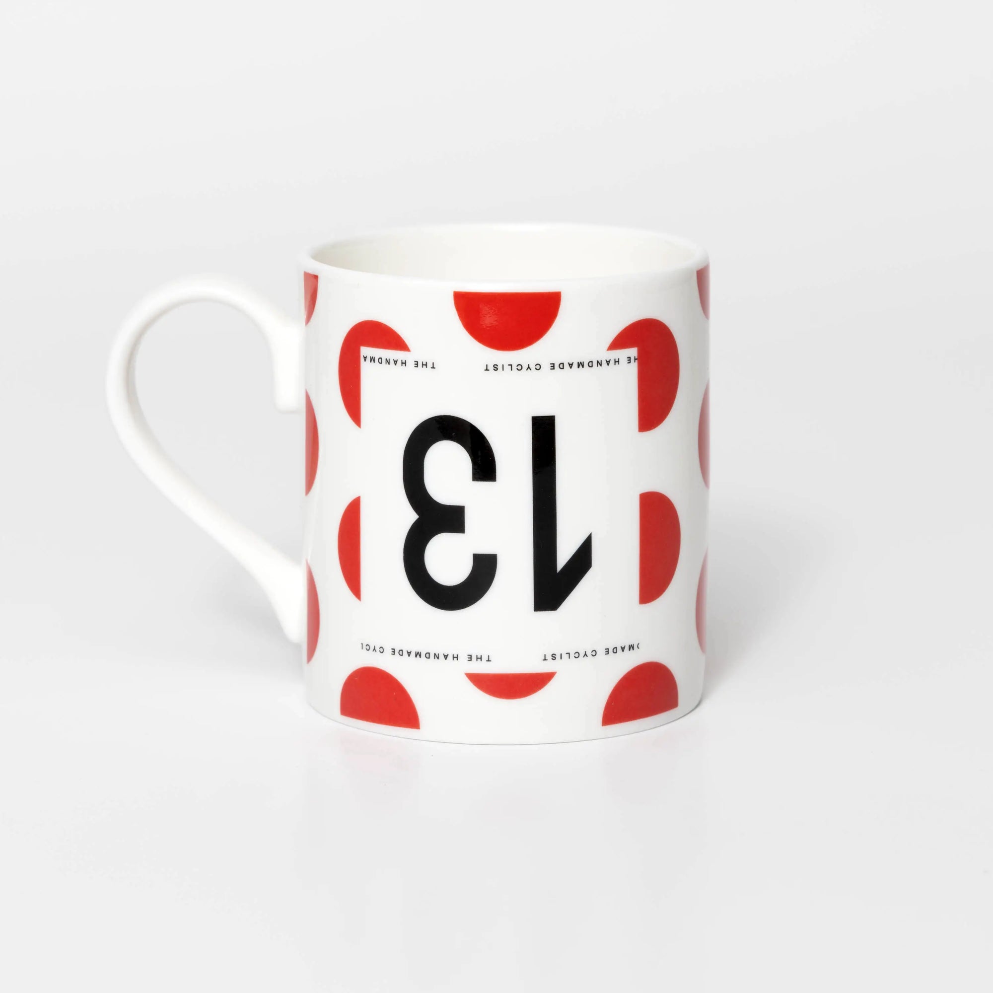 Mug featuring the number 13 upside down on a polka dot back ground in the style of Tour de France King of the Mountains jersey.