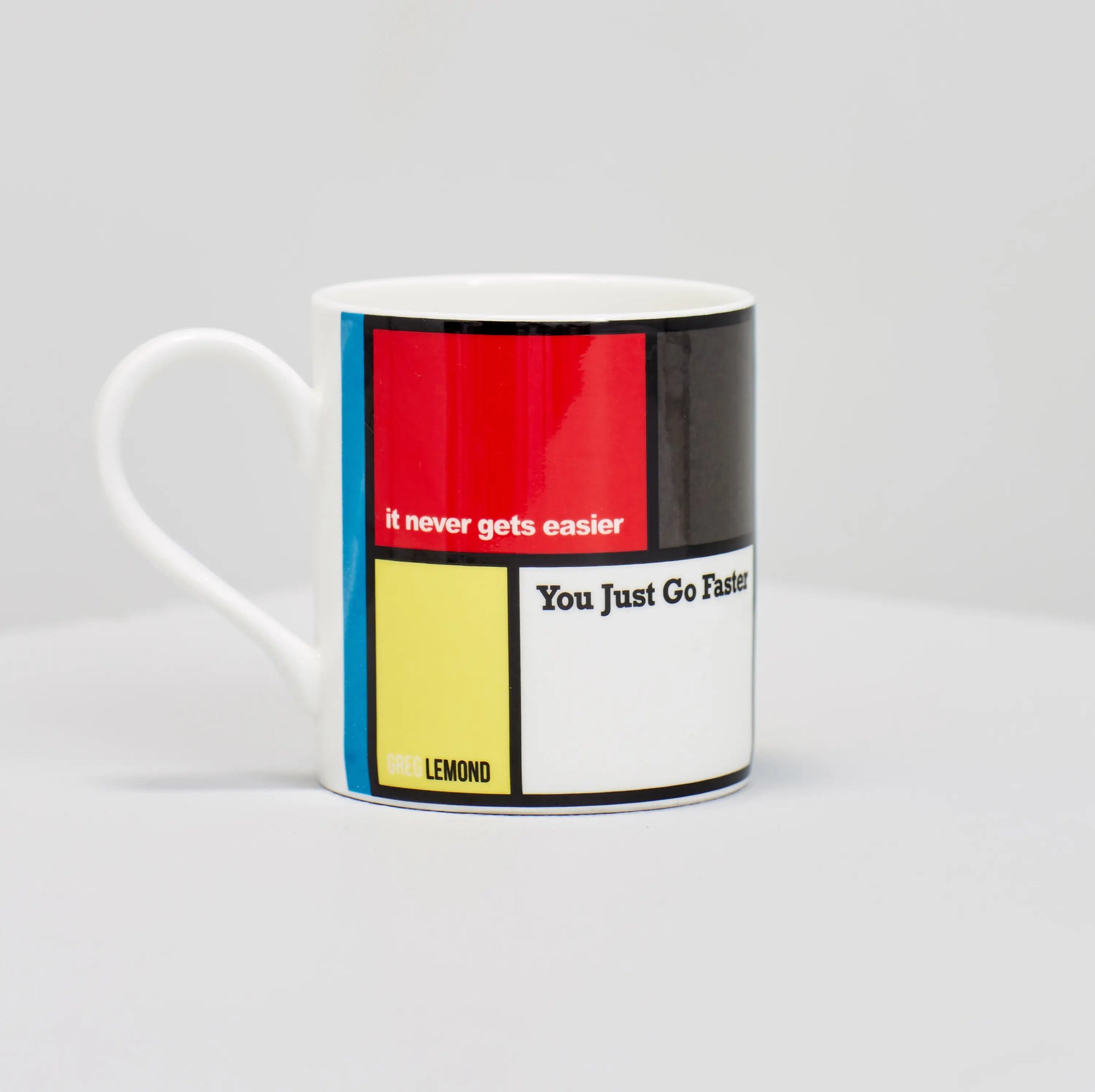 Greg Lemond famous cycling quote "it never gets easier, you just go faster" on coffee mug.