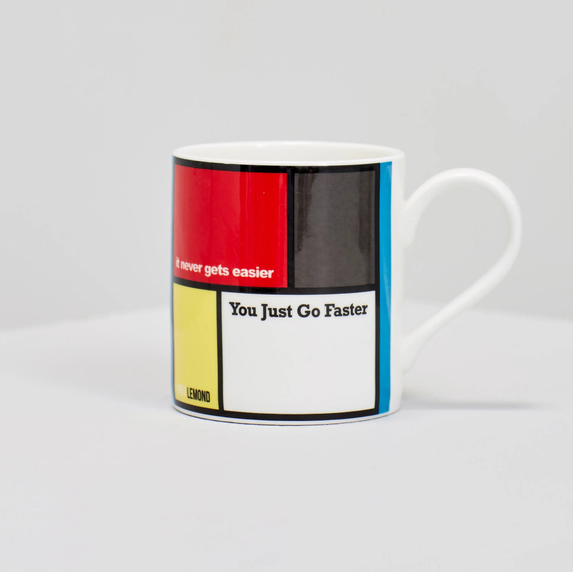 Greg Lemond famous cycling quote "it never gets easier, you just go faster" on coffee mug.