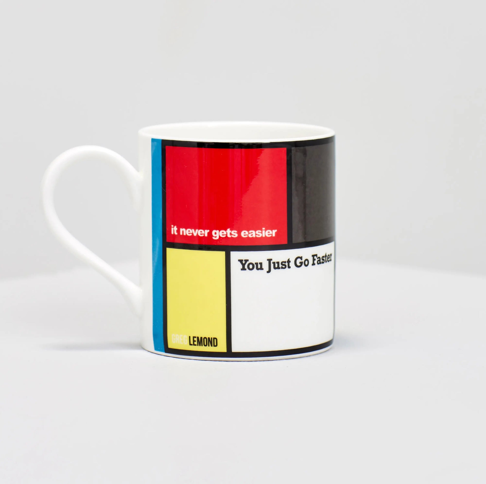 Greg Lemond famous cycling quote "it never gets easier, you just go faster" on coffee mug.