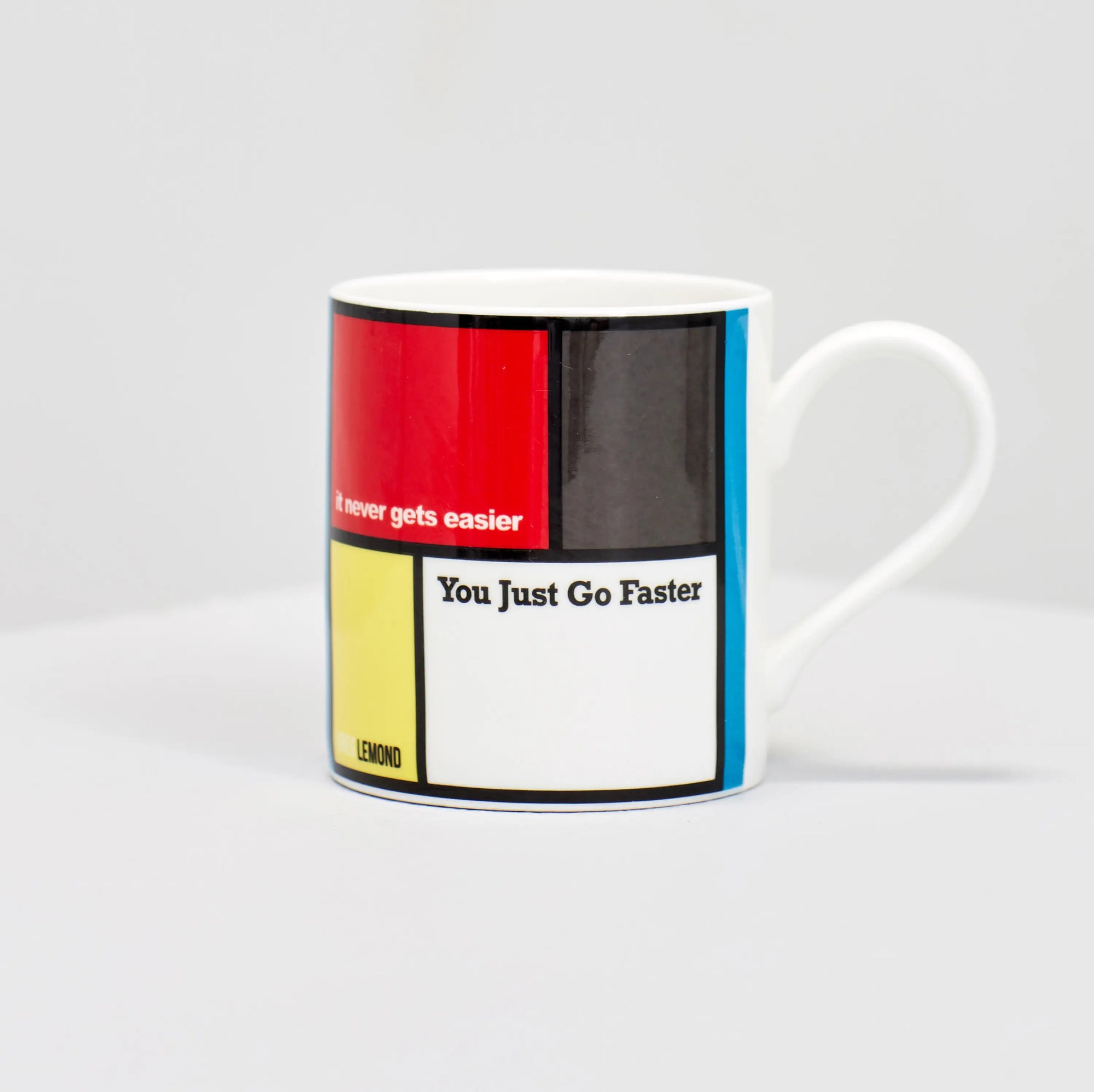 Greg Lemond famous cycling quote "it never gets easier, you just go faster" on coffee mug.